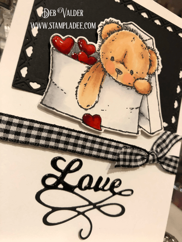 Love Bear in an envelope with Valentine hearts.